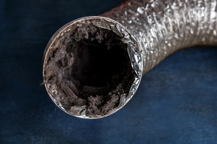 Interior of a flexible dryer duct clogged with heavy lint buildup